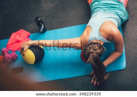 Woman worming up and stretching her body at the gym.Pilates. Royalty-Free Stock Photo #348239339