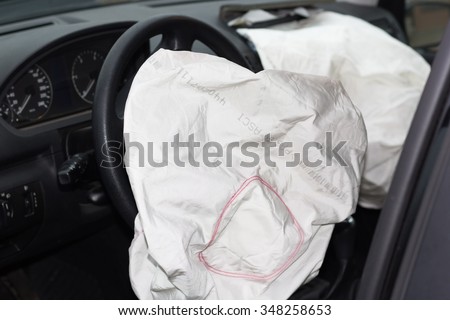 deflated airbags after the erupted inflation due to a car collision Royalty-Free Stock Photo #348258653