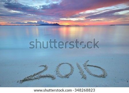 new year 2016 digits on ocean beach sand