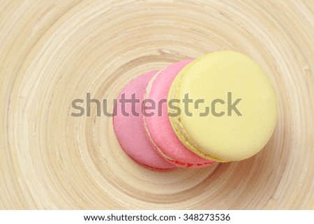 Tasty colorful French macaroons over bamboo background