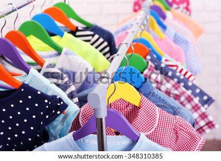 Children clothes on hangers closeup