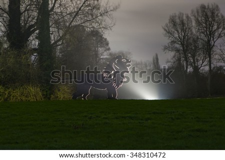 Silhouette of a Lion in the Enchanted Woodland in Syon Park, London.
