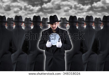 Man showing the clock while standing out from the crowd