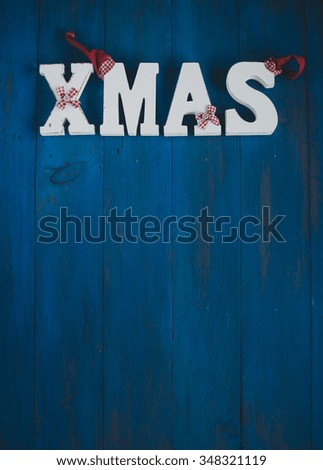 Word "XMAS" on a vintage wooden background. Christmas card