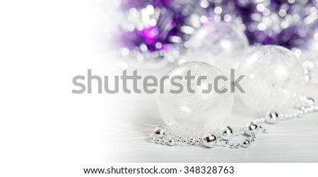 Glass globes and silver beads on background with space for text, card golden for the winter holidays, xmas, Christmas and New Year