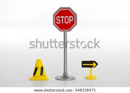 Stop road sign and toy road sign with traffic cone