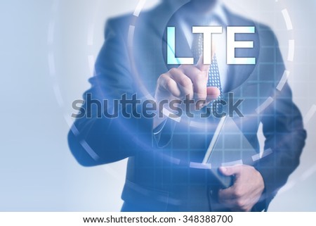 Businessman pressing button on touch screen interface and select LTE. Business, internet, technology concept.