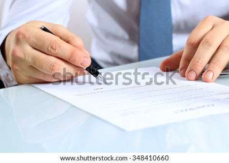 Businessman is signing a contract, business contract details