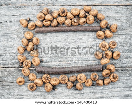 Still life composition/ frame with tiny acorns on an old wooden surface. Beautiful vintage composition