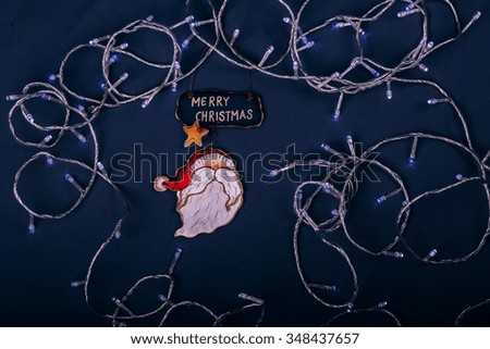 Merry Christmas inscription with santa claus miniature