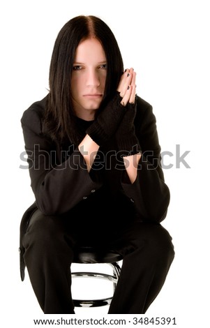 Young gothic man sitting on a bar chair