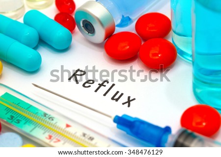 Reflux- diagnosis written on a white piece of paper. Syringe and vaccine with drugs. Royalty-Free Stock Photo #348476129