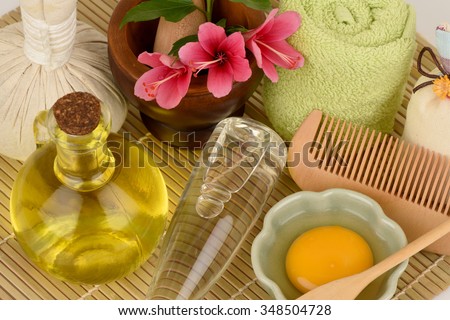 Treatments hair with flowers Hibiscus, olive oil, coconut oil and egg yolks. Royalty-Free Stock Photo #348504728