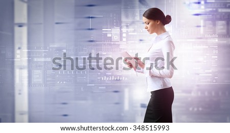 Businesswoman with tablet pc against high tech blue background