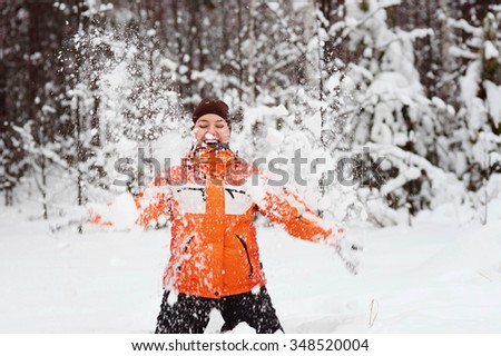 Happy Woman at Falling Snow with Open Arms 