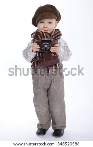 little funny boy with aged retro camera