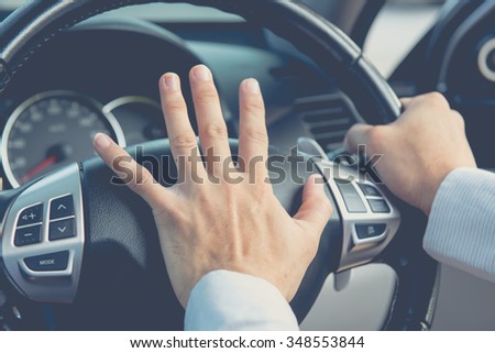 Photo of driver honking in traffic on the road Royalty-Free Stock Photo #348553844