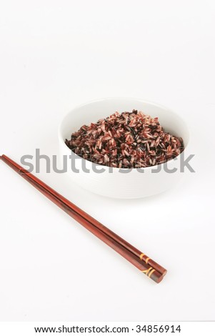 dark mixed rice in white bowl with sticks
