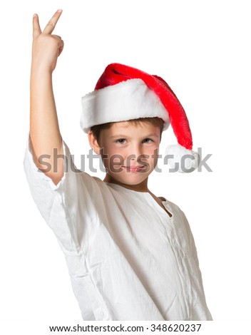 Very beautiful seven year old boy in a red cap. He shows two fingers victory. Picture taken on a white background