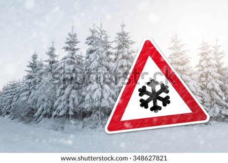 warning sign with snow flake for snowfall at the winter season