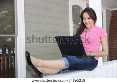 Pretty Girl Studying on Home Porch with Laptop Computer