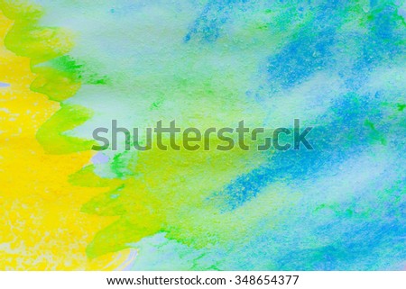 blue, yellow and green watercolors on textured paper background