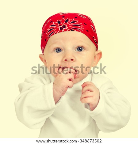 Toned Photo of Funny Baby Boy in Headscarf
