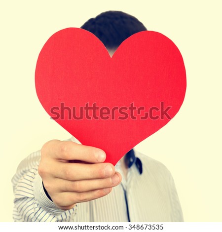 Toned Photo of Person hold Red Heart Shape