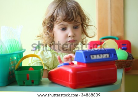 little girl plays shop