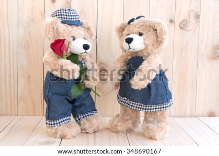 couple teddy bears with rose on wood background, teddy bear love concept for valentines day, wedding and anniversary