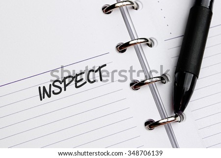 INSPECT word written on notebook