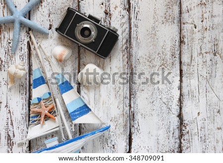 top view image of wood boat, sea shells and star fish over wooden table 