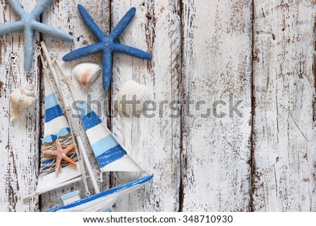 top view image of wood boat, sea shells and star fish over wooden table 