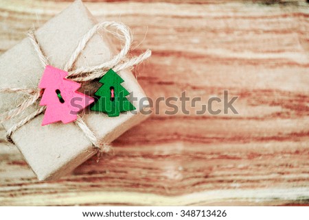 Vintage gift box with Christmas tree on old wooden background.