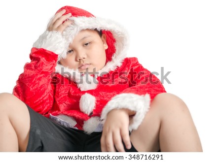 Little Asian fat boy in santa costume waiting for Christmas presents isolated