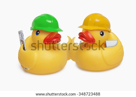 Child's toy rubber ducks dressed as construction workers in conversation.
