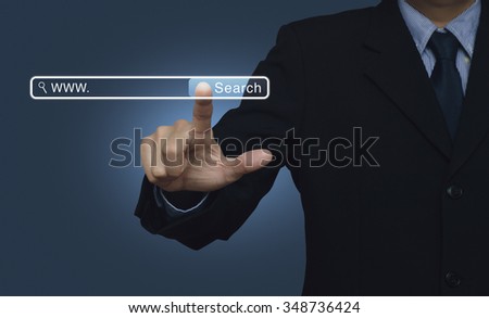 Businessman hand pressing search button over blue background, searching system and internet concept
