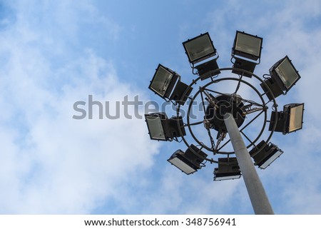 Round sport light with blue cloud sky background with space for text.
