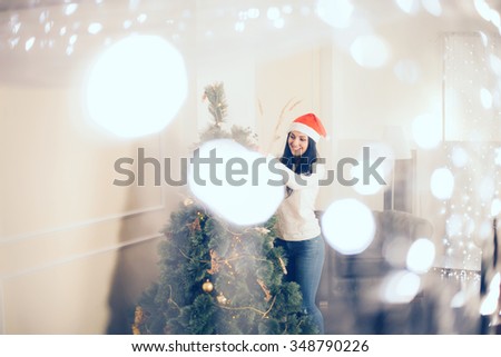Beautiful Christmas. Bright picture of woman decorating christmas tree