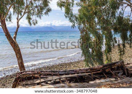 an old destroyed boat on the beach in grecce