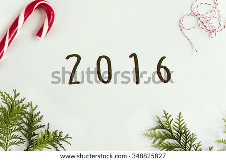 green branches and amazing christmas toys and sweets on white background, 2016 text