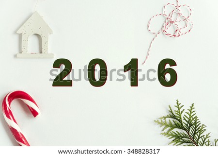 green branches and amazing christmas toys and sweets on white background, 2016 text