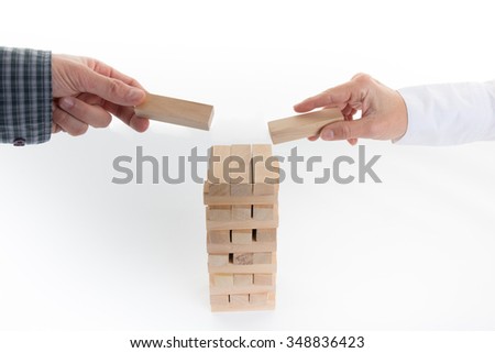 House made with wooden block man and woman hands isolated on white background