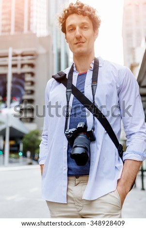 Happy male tourist in casual clothes in city walking