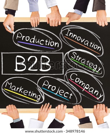Photo of business hands holding blackboard and writing B2B concept