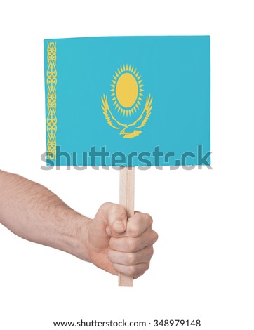 Hand holding small card, isolated on white - Flag of Kazakhstan