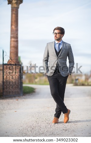 Fashion model man posing in autumn park. Smart casual outfit. Royalty-Free Stock Photo #349023302