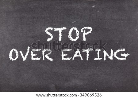 Stop over eating, concept on school blackboard or chalkboard