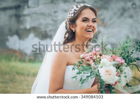Laughing bride with rustic bouquet