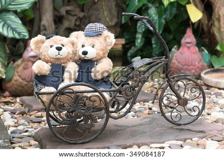 couple teddy bears with a bicycle on garden background, two teddy bear picnic in garden love concept